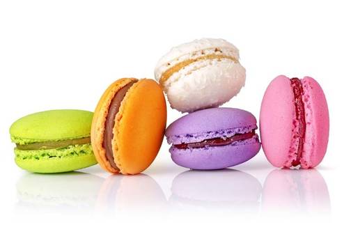 a light often brightly colored sandwich cookie consisting of two rounded disks made from a batter of egg whites sugar and almond flour surrounding a sweet filling as of ganache